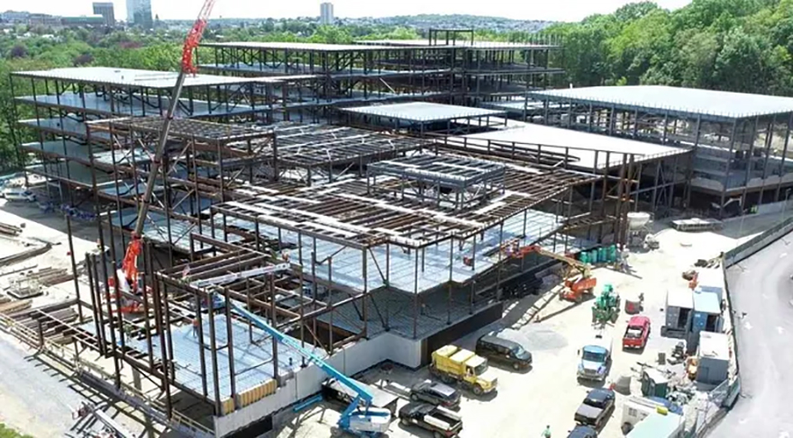 A group of construction workers in hard hats and safety vests.